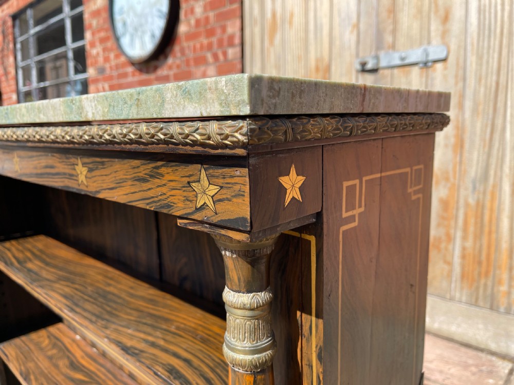 An early nineteenth-century open bookcase featuring a simulated rosewood painted finish, green marble top, gilt star motifs, and turned side columns. View V