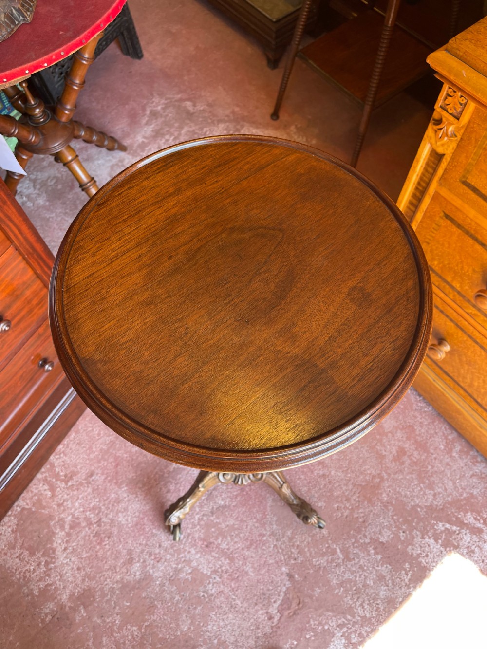 A nineteenth-century height-adjustable stand featuring a circular mahogany tabletop, a spiralled column with a wing nut mechanism, and an ornate cast metal base with castors. View III