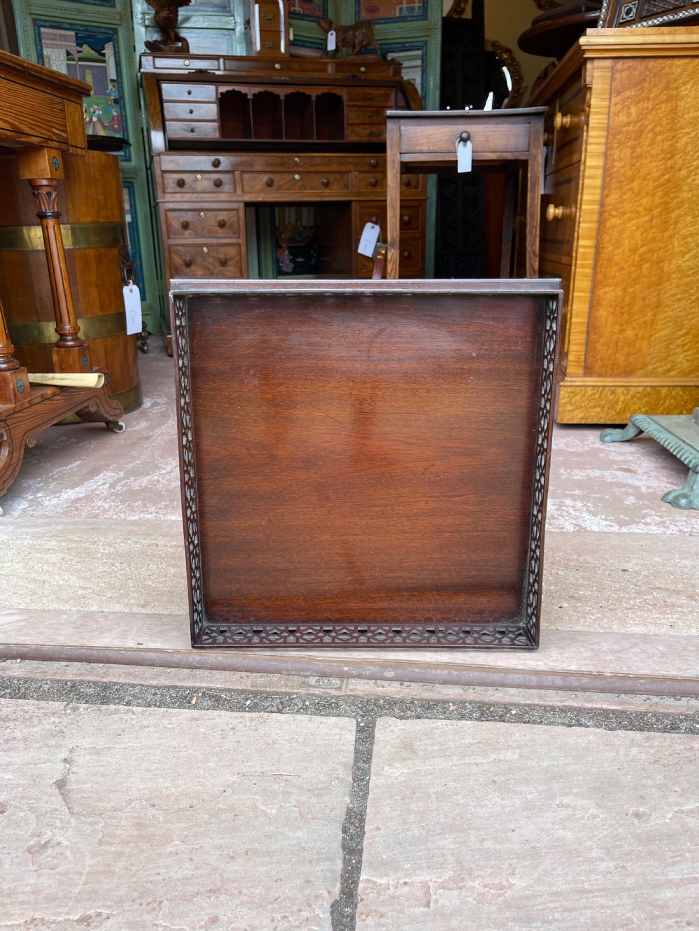 A tall mahogany pedestal side table featuring a square top with a fretwork gallery, a turned stem, and three splayed legs. View III