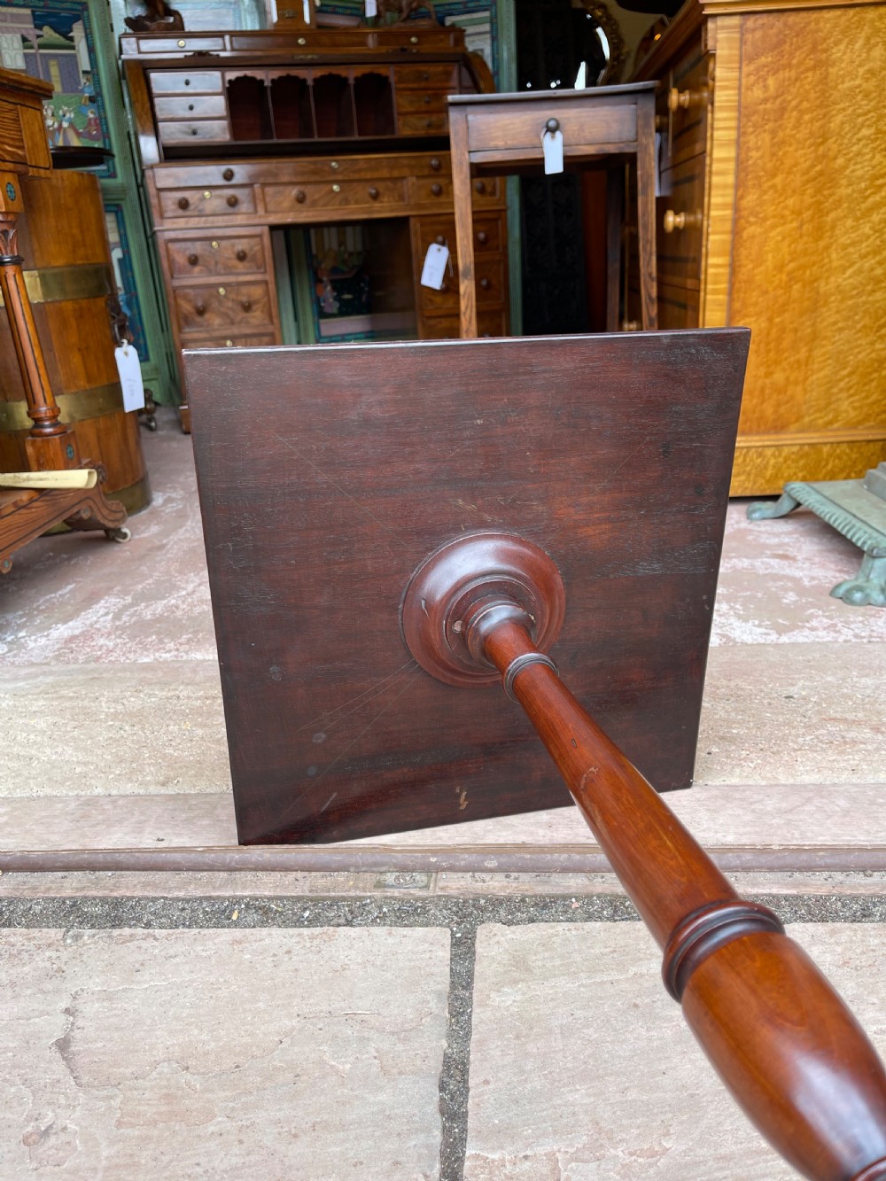 A tall mahogany pedestal side table featuring a square top with a fretwork gallery, a turned stem, and three splayed legs. View IV