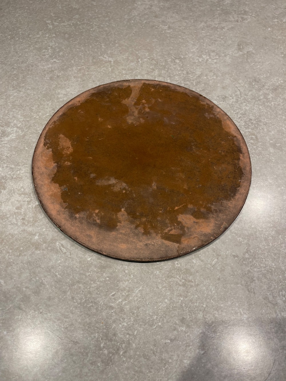 A circular bevelled glass mirror plate decorated with cut starburst and floral wheel motifs around the perimeter. View II