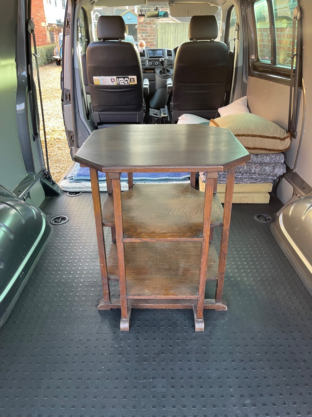 A dark oak three-tier occasional table featuring an octagonal top surface supported by straight legs and two square lower shelves.