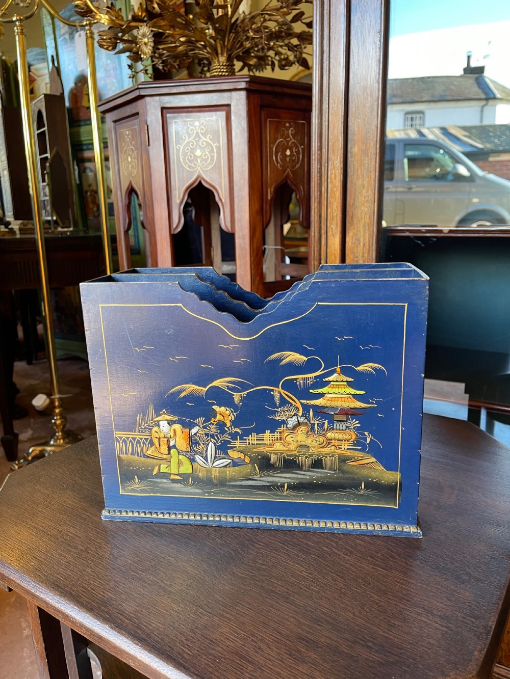 A blue painted wooden stationery desk tidy decorated with hand-painted gilt Chinoiserie scenes featuring figures and pagodas, with shaped internal letter dividers. View III