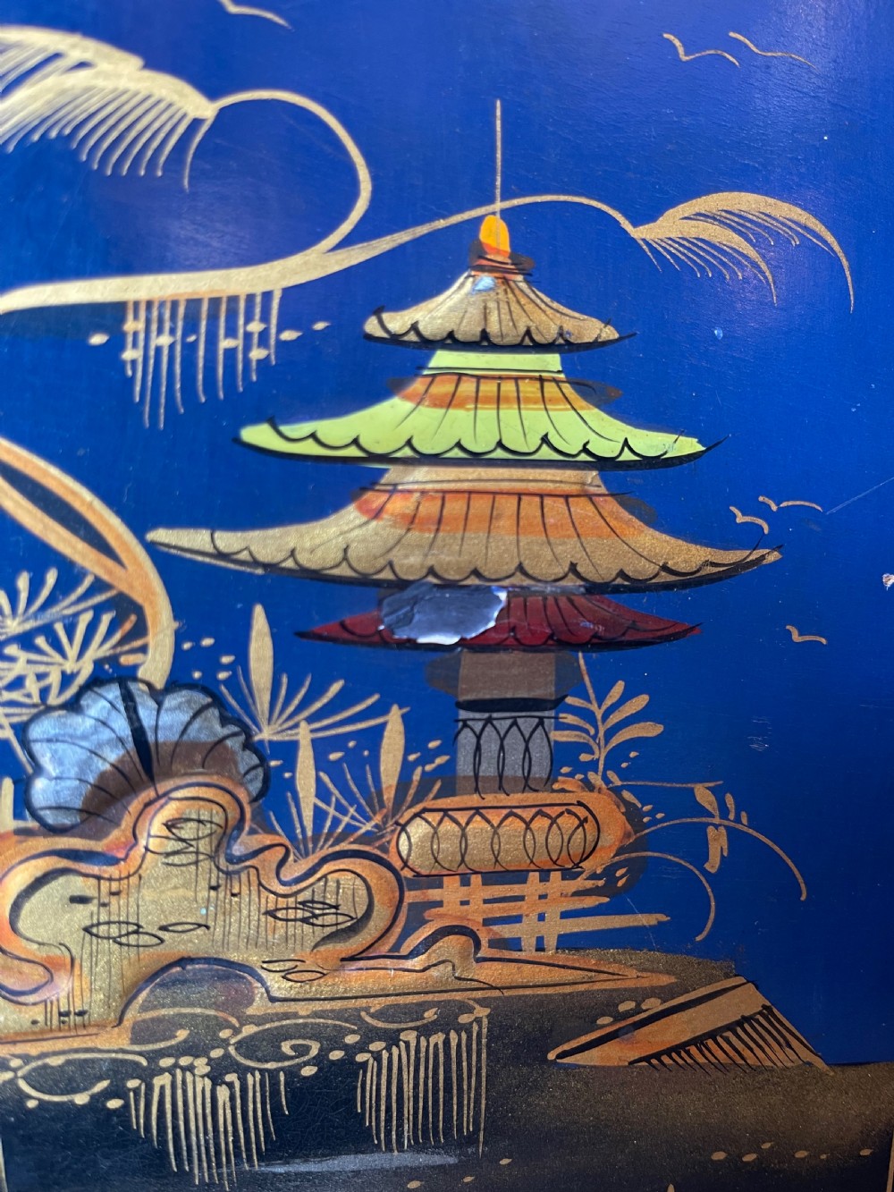 A blue painted wooden stationery desk tidy decorated with hand-painted gilt Chinoiserie scenes featuring figures and pagodas, with shaped internal letter dividers. View IV