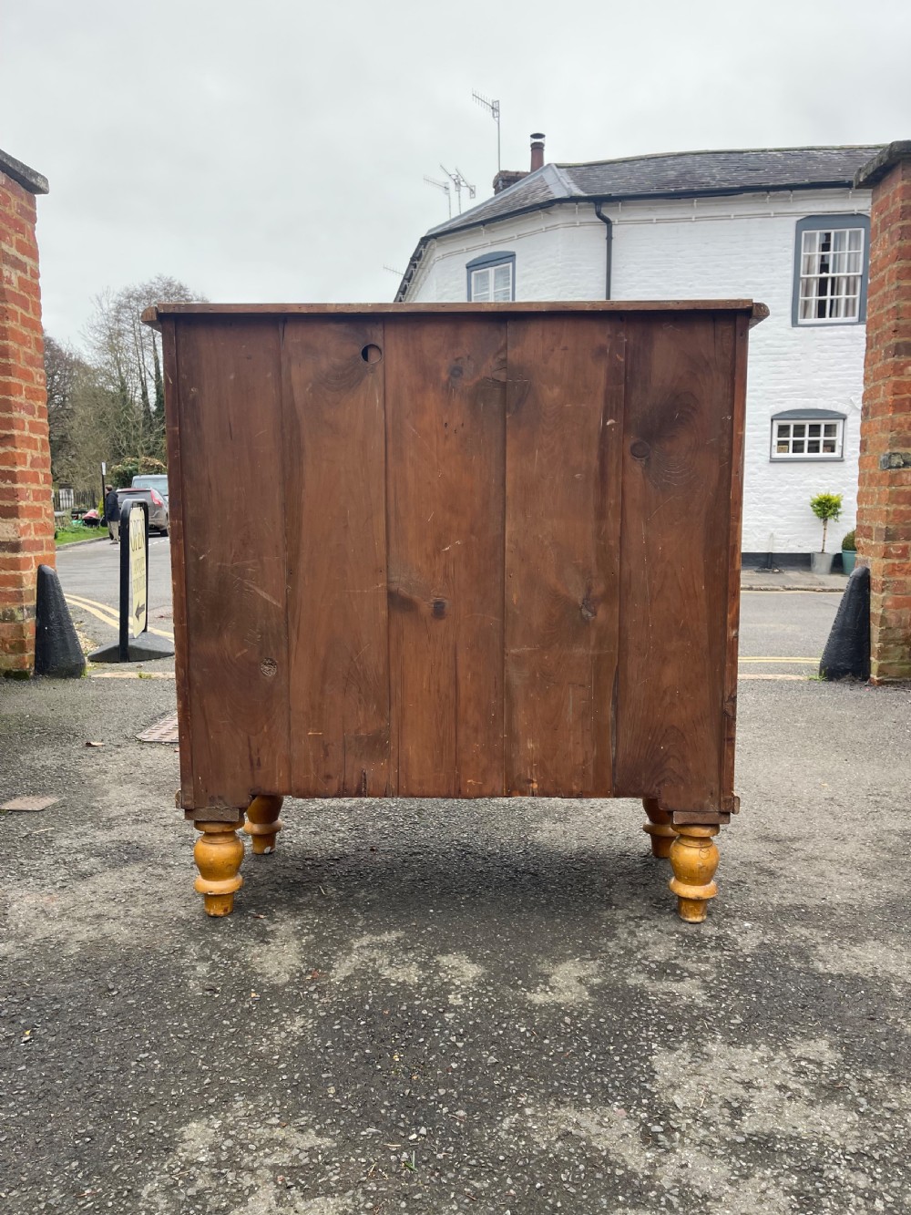 Victorian honey pine chest of drawers featuring two short drawers over three long drawers with dark turned knobs and painted decorative corner accents. View VIII