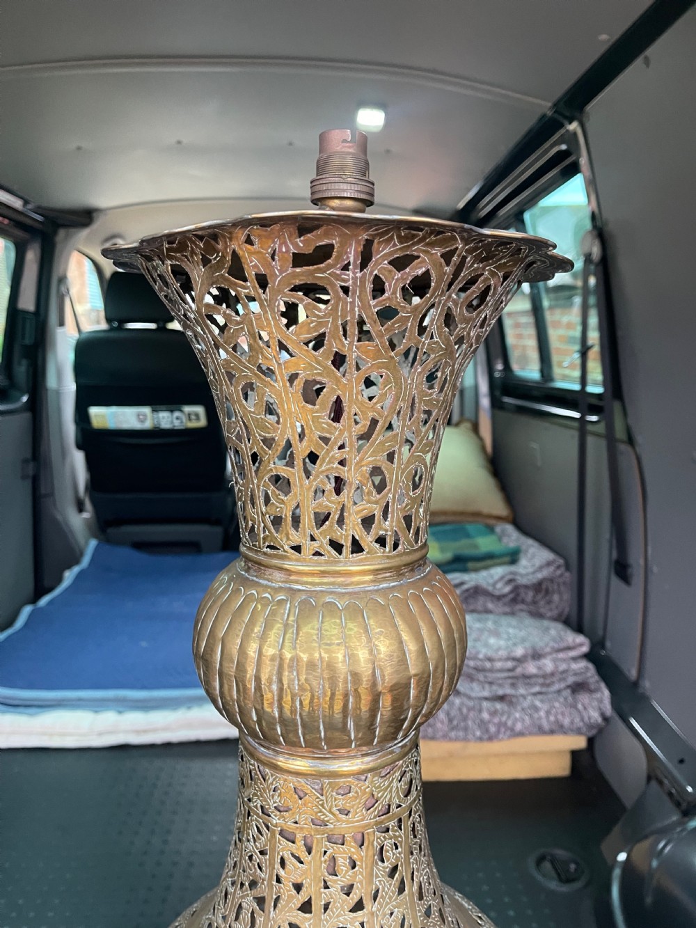 A pair of large antique brass Cairoware lamps featuring intricate pierced arabesque metalwork and tiered urn-shaped bodies. View III