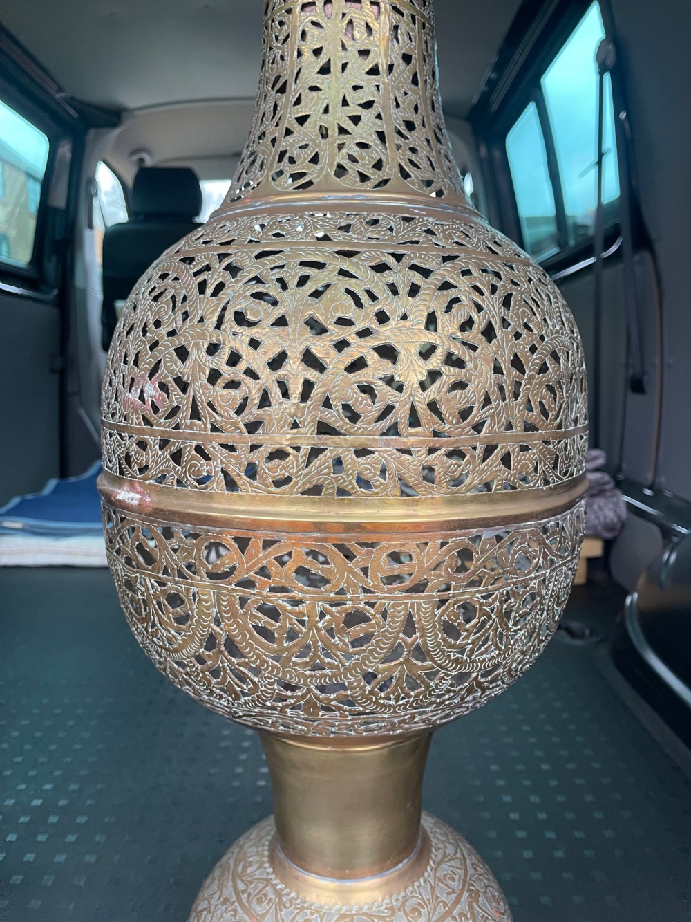 A pair of large antique brass Cairoware lamps featuring intricate pierced arabesque metalwork and tiered urn-shaped bodies. View V