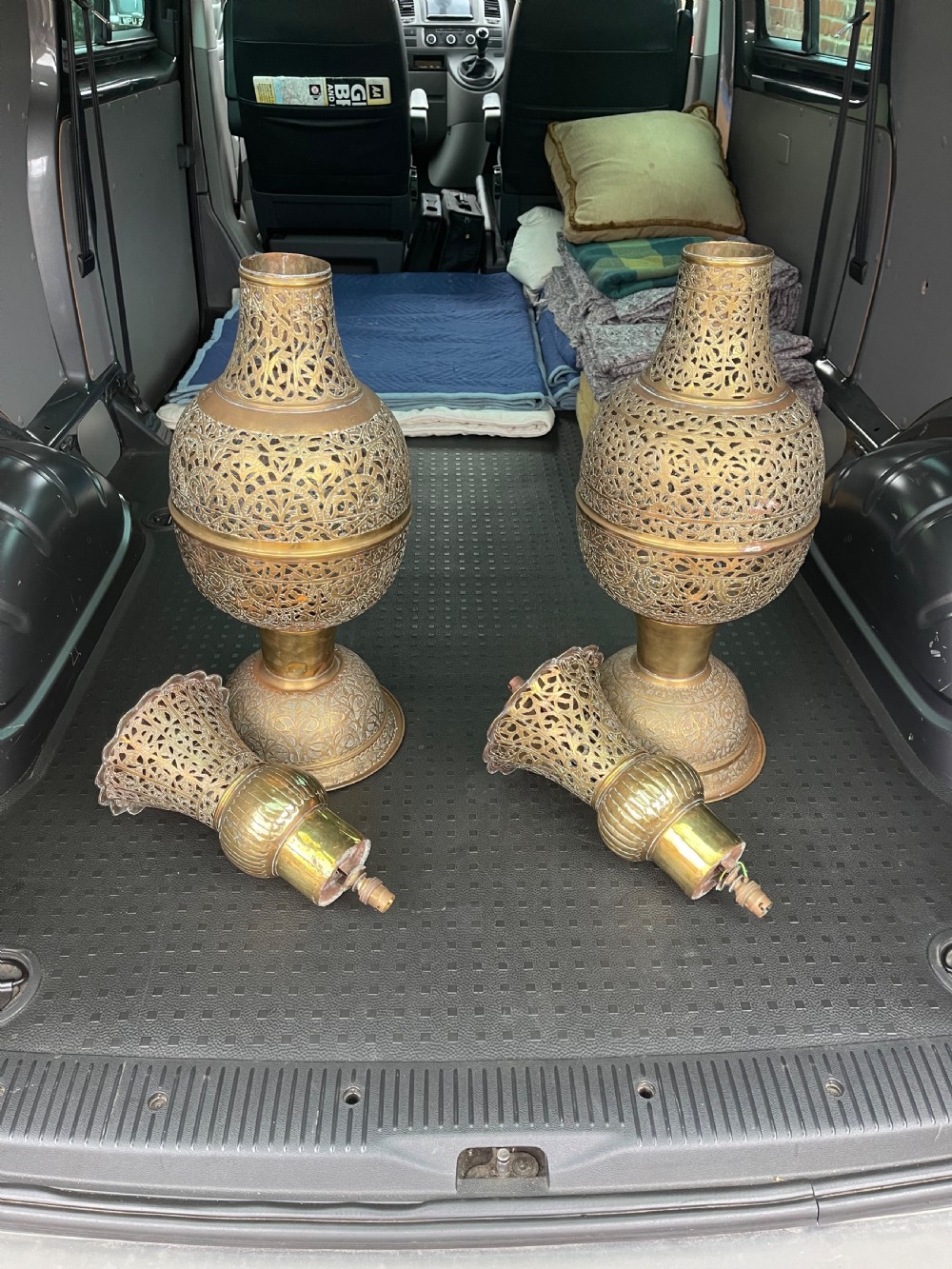 A pair of large antique brass Cairoware lamps featuring intricate pierced arabesque metalwork and tiered urn-shaped bodies. View VII