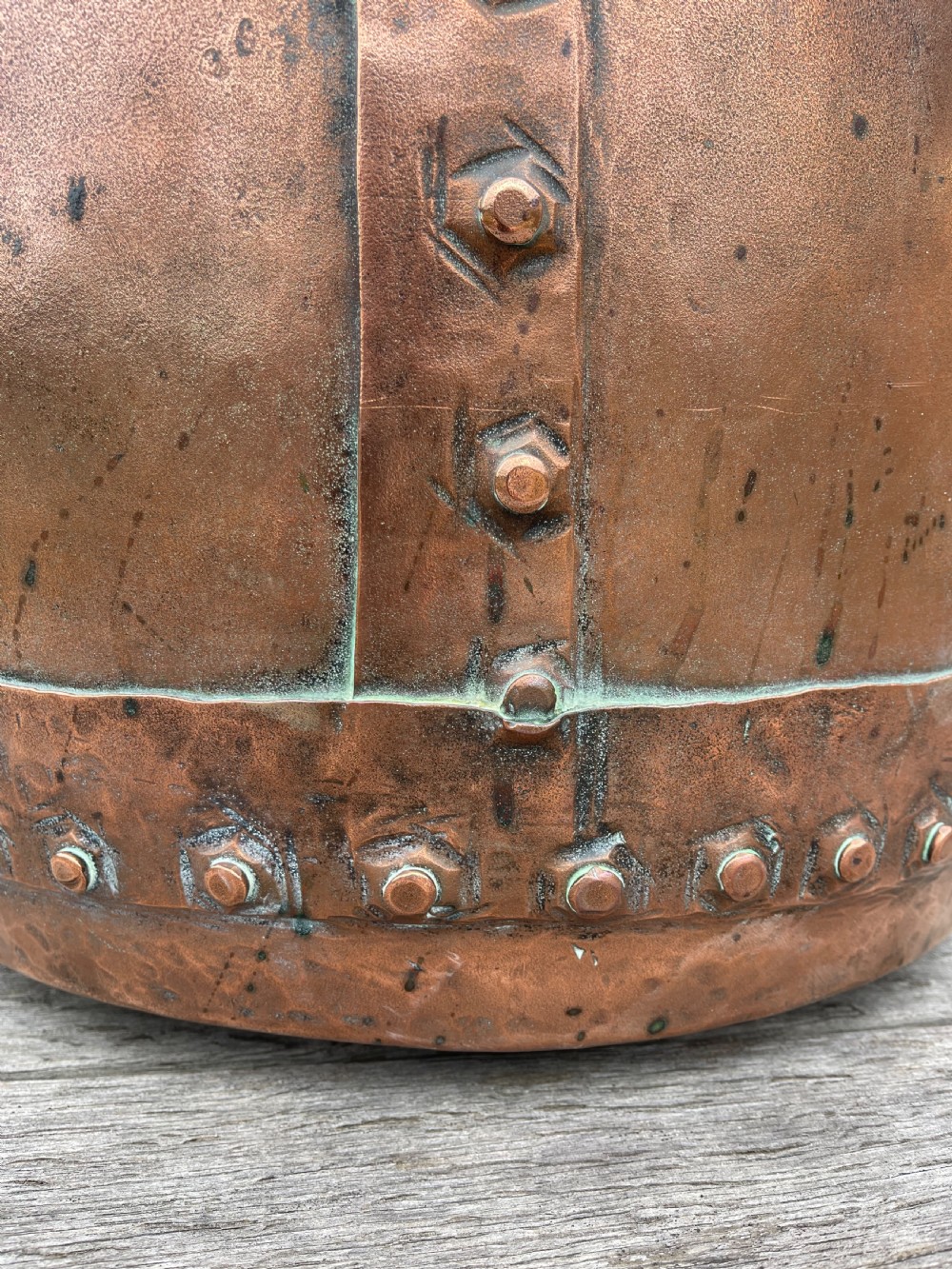 A large nineteenth-century cylindrical copper tub featuring heavy riveted vertical seams and a natural weathered patina. View IV