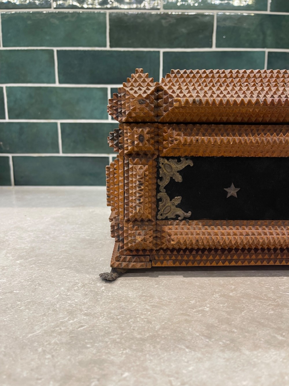 An antique tramp art box featuring layered notch-carved brown wood, dark velvet panels, metal corner mounts, and claw feet. View II