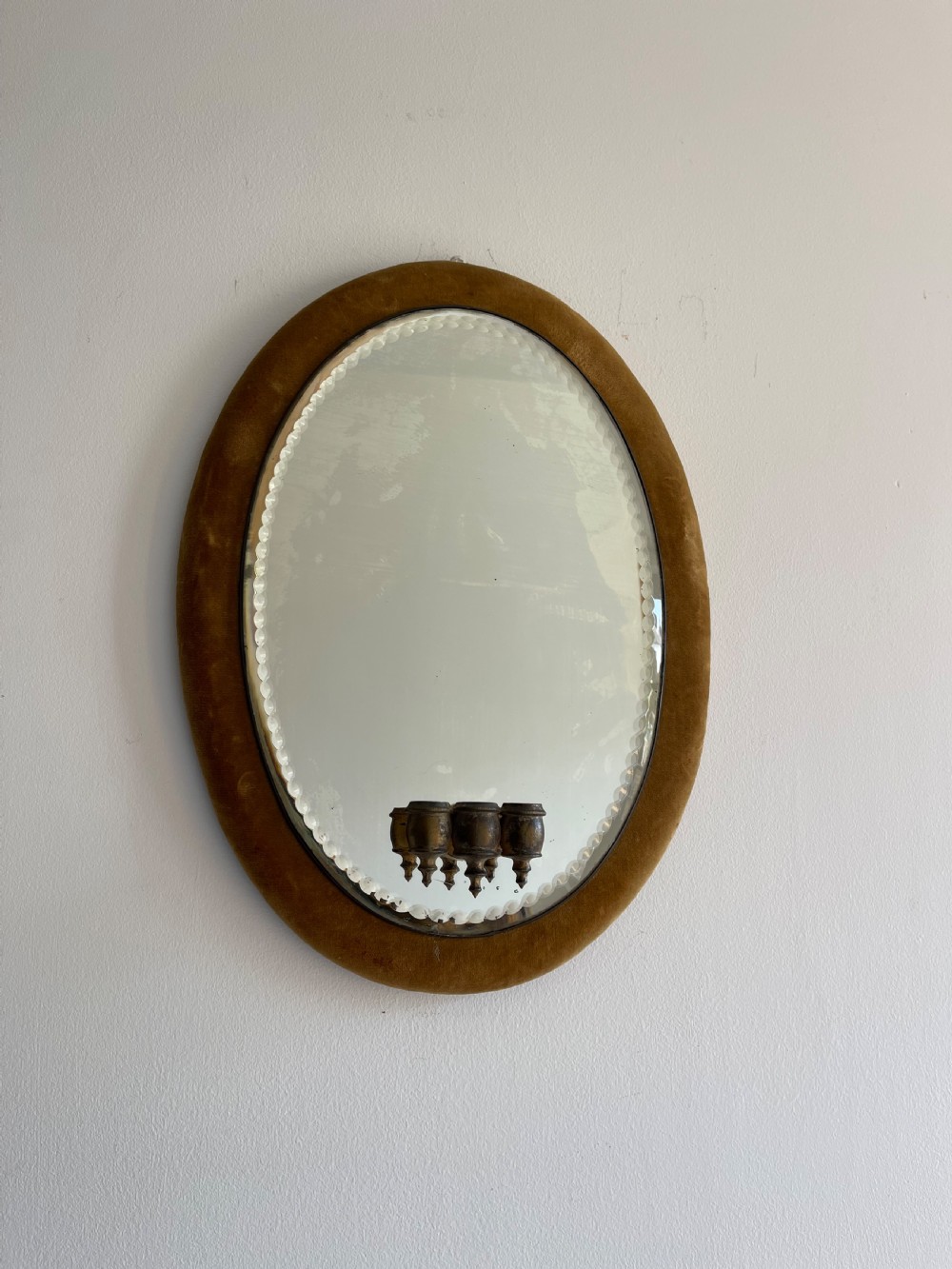 Velvet framed mirror with candle sconce. 