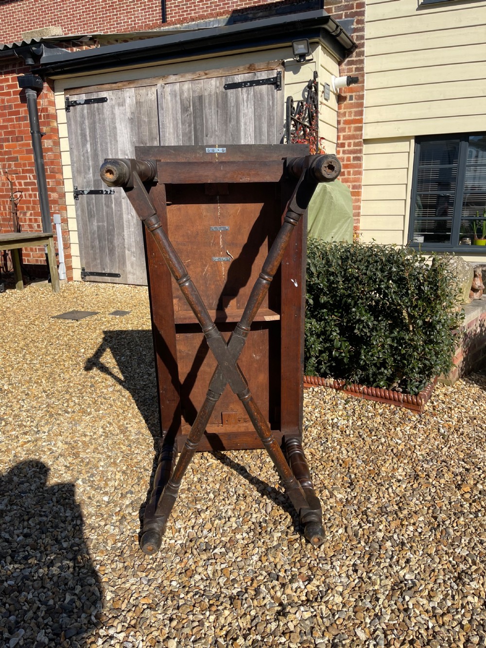 A nineteenth-century rectangular dark oak table featuring turned legs, a turned X-frame stretcher base, and a side drawer. View III