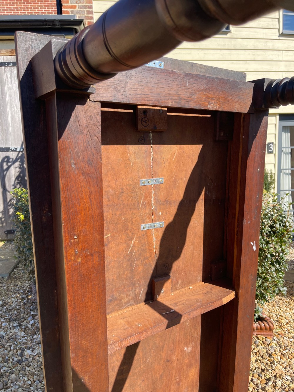 A nineteenth-century rectangular dark oak table featuring turned legs, a turned X-frame stretcher base, and a side drawer. View IV