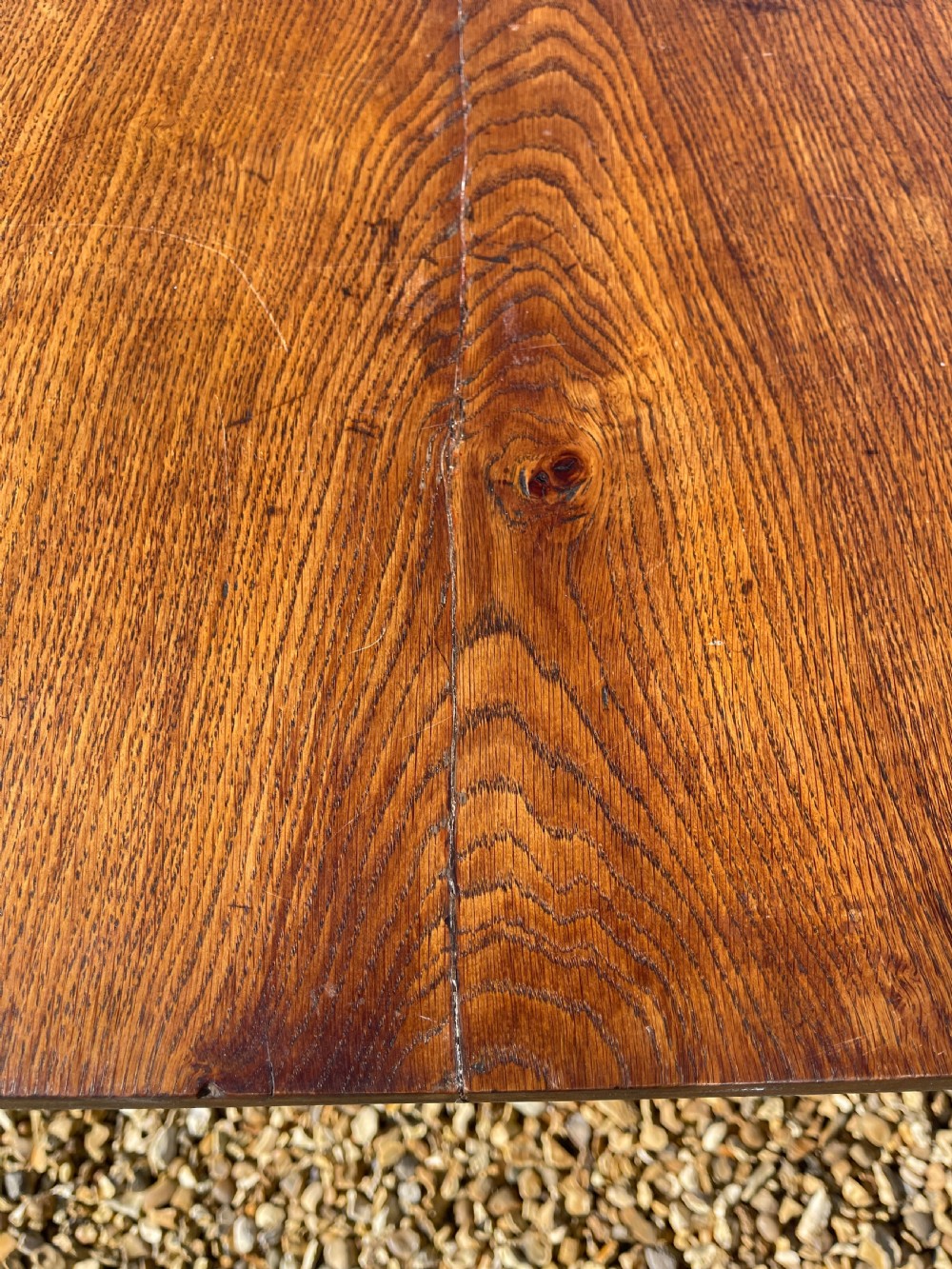 A nineteenth-century rectangular dark oak table featuring turned legs, a turned X-frame stretcher base, and a side drawer. View V