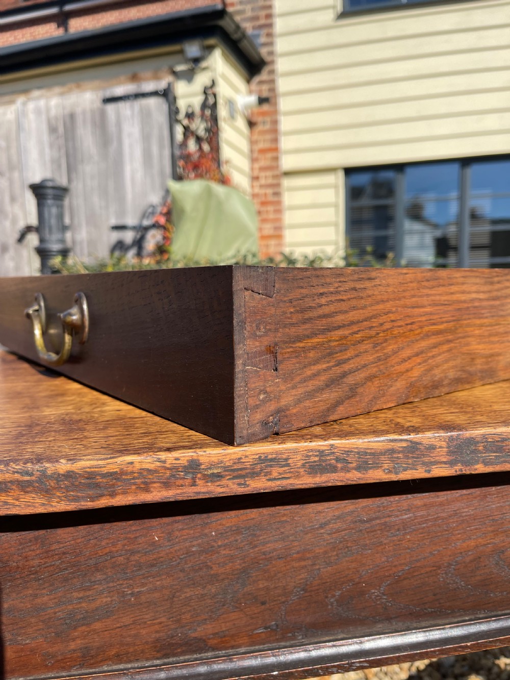 A nineteenth-century rectangular dark oak table featuring turned legs, a turned X-frame stretcher base, and a side drawer. View VII