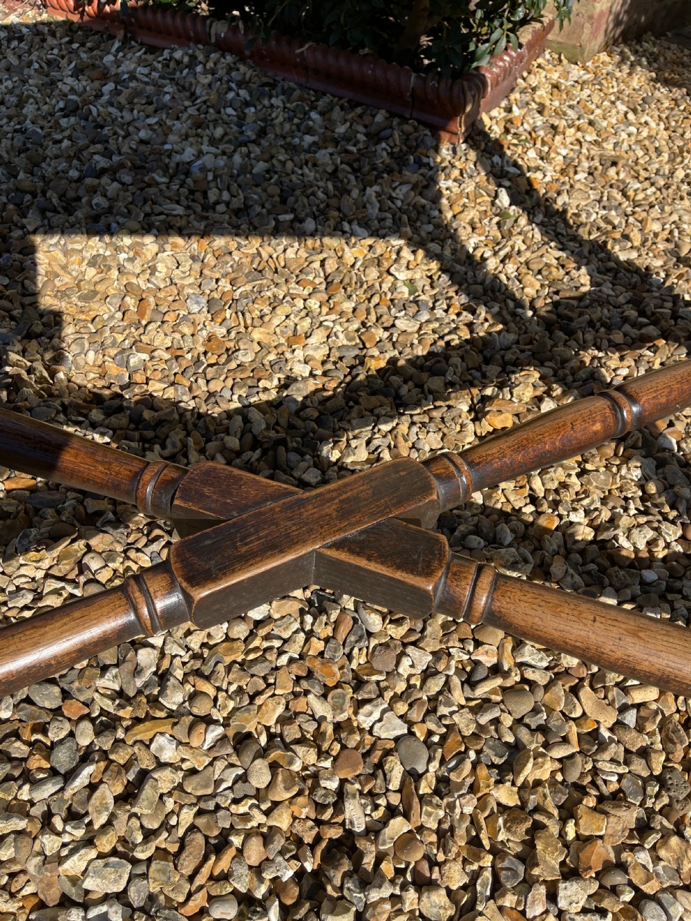 A nineteenth-century rectangular dark oak table featuring turned legs, a turned X-frame stretcher base, and a side drawer. View IX