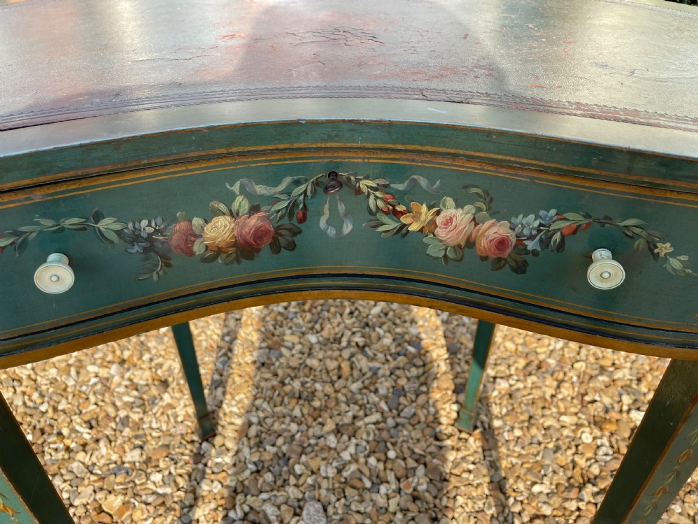 A late Victorian kidney-shaped writing desk finished in green paint with hand-painted floral swags and an inset leather top. View VI