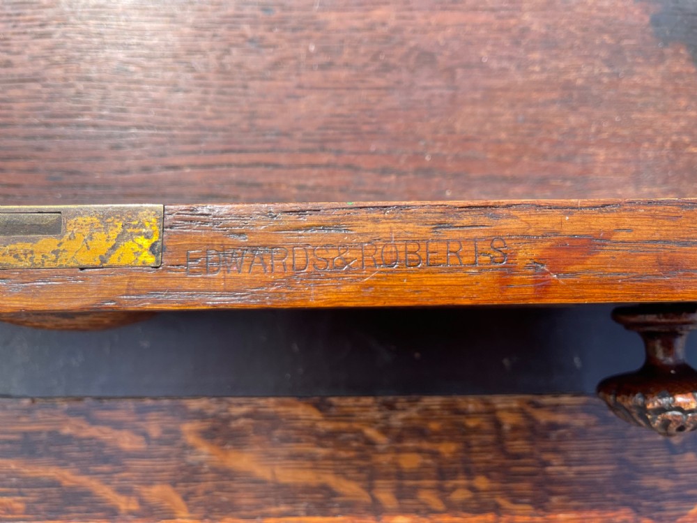 A late Victorian dark oak pedestal desk featuring intricate relief carving across all drawer fronts and a detailed raised superstructure. View XVII