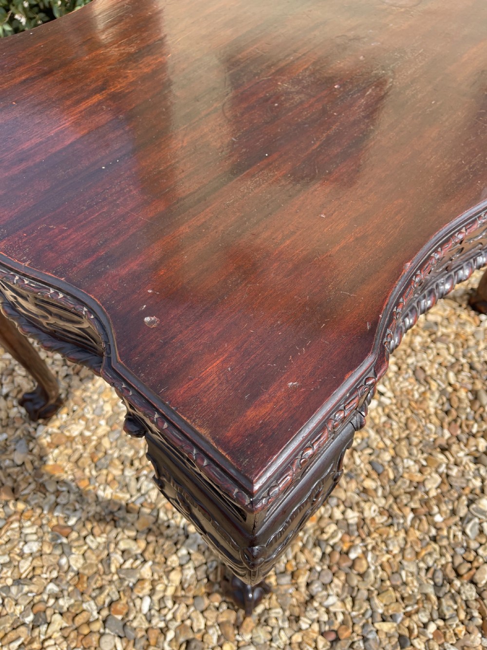 A dark mahogany Chippendale style side table featuring carved ball-and-claw feet, carved knees, and a blind fretwork apron. View III