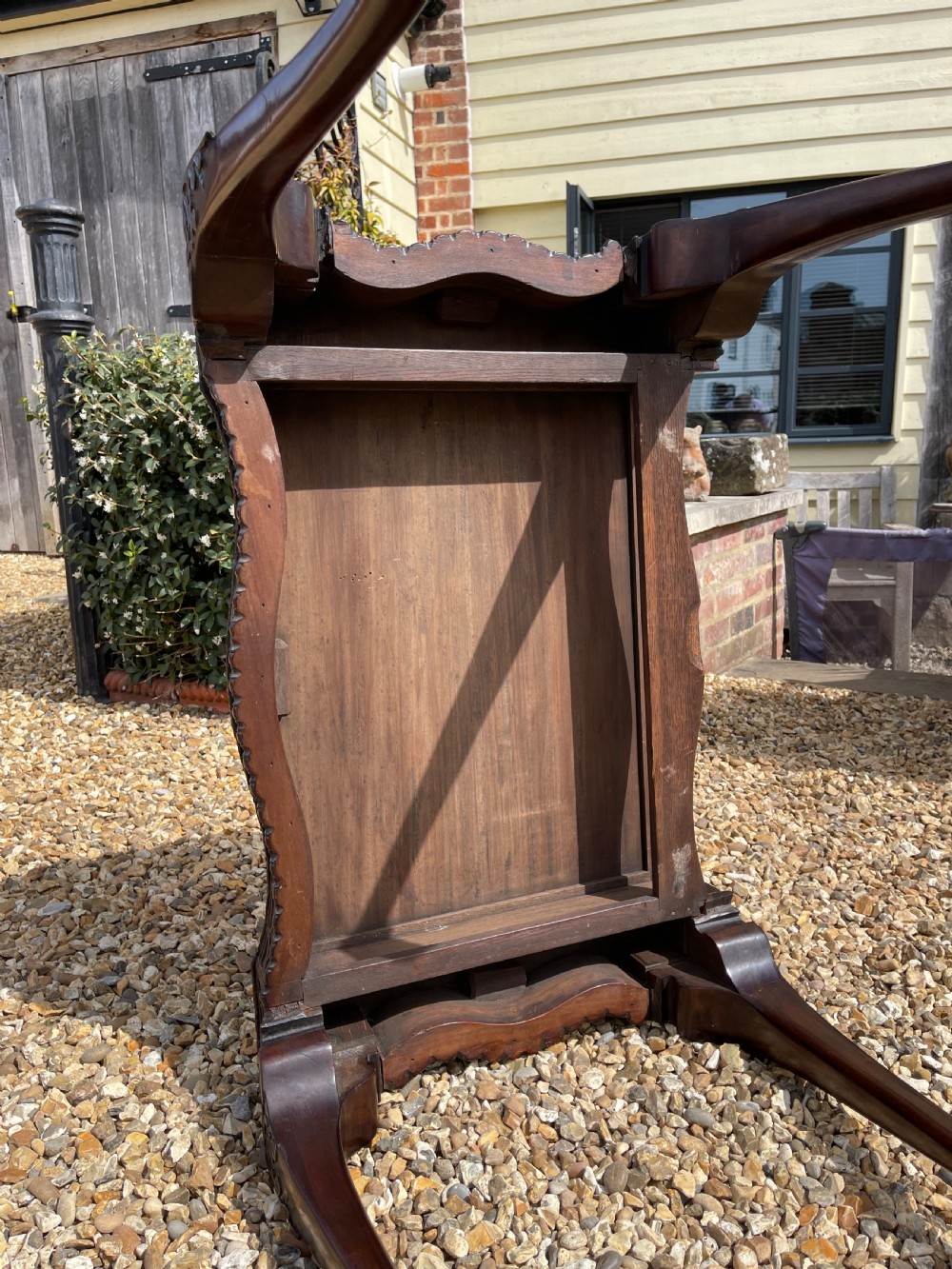 A dark mahogany Chippendale style side table featuring carved ball-and-claw feet, carved knees, and a blind fretwork apron. View V