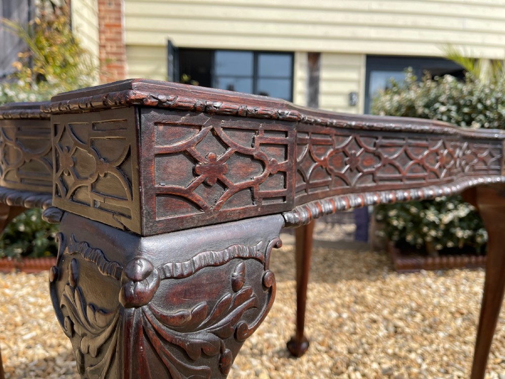 A dark mahogany Chippendale style side table featuring carved ball-and-claw feet, carved knees, and a blind fretwork apron. View VII