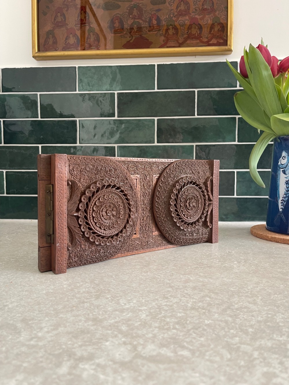 An antique carved warm brown wooden expandable book slide with intricate floral relief carving on arched folding end panels. View VI