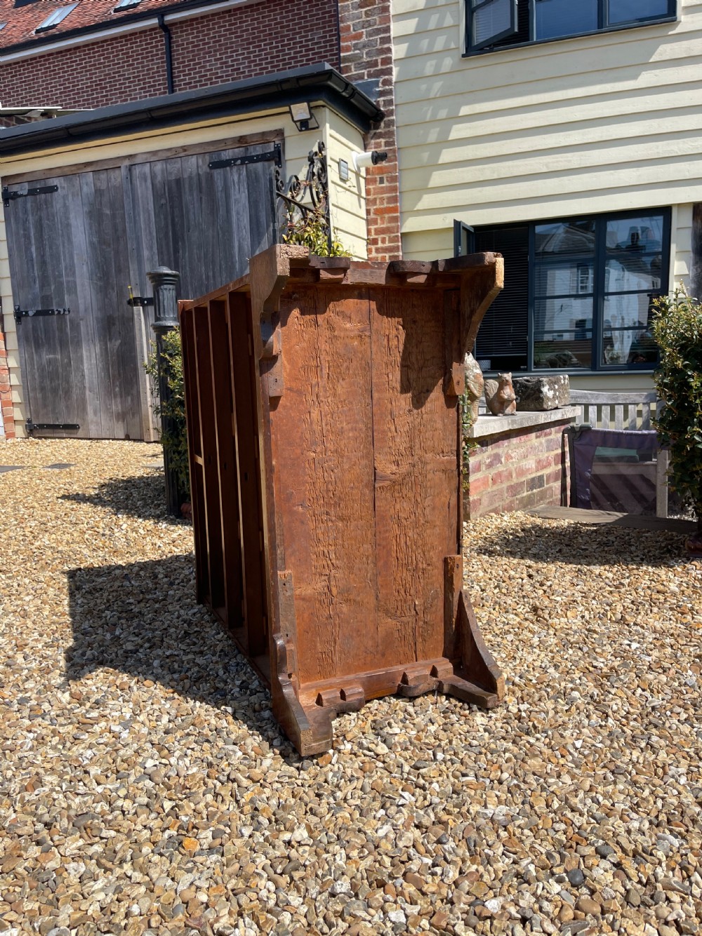A George III wooden chest of drawers featuring two short drawers over three long graduated drawers, fitted with brass handles and supported on bracket feet. View IX