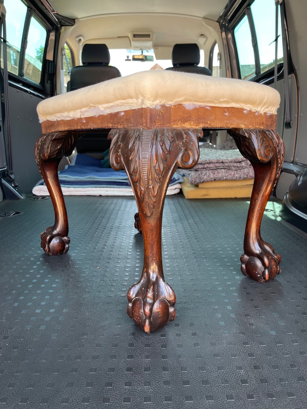 A Georgian style stool with dark carved mahogany cabriole legs ending in ball and claw feet and a padded rectangular seat. View III