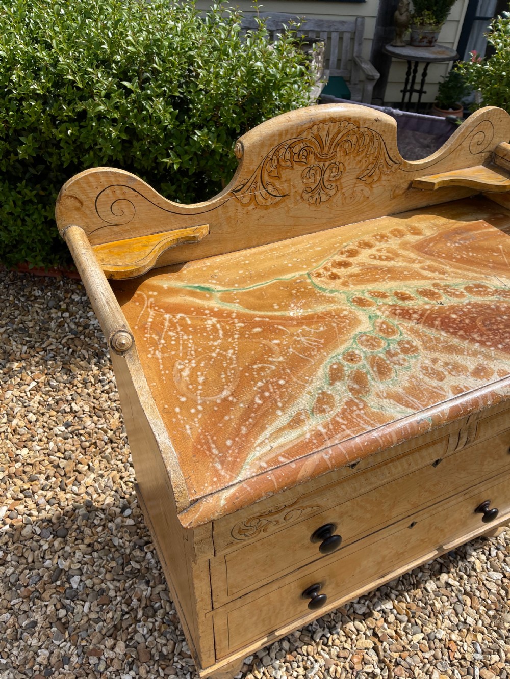 A nineteenth-century pine chest of drawers with scumble paint finish, carved gallery, turned wooden knobs, and turned feet. View VI