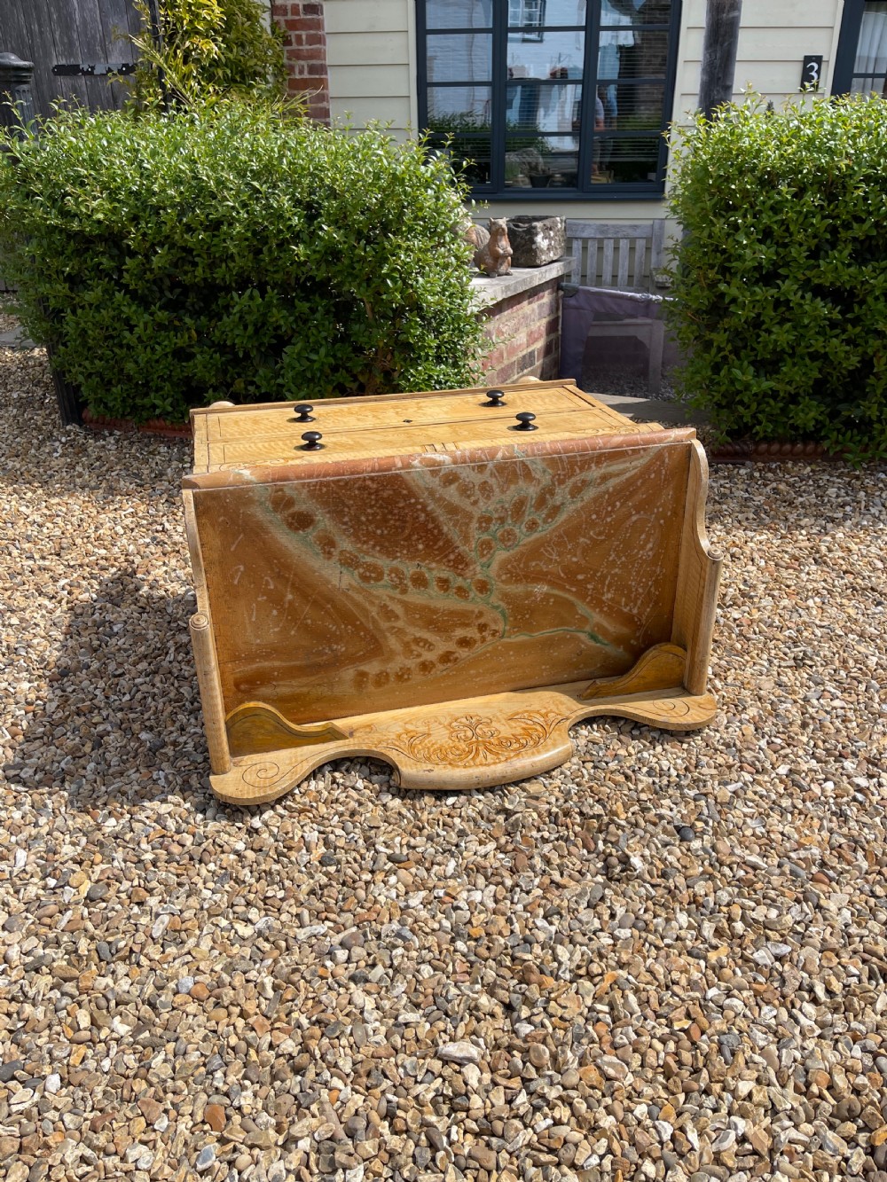 A nineteenth-century pine chest of drawers with scumble paint finish, carved gallery, turned wooden knobs, and turned feet. View VIII