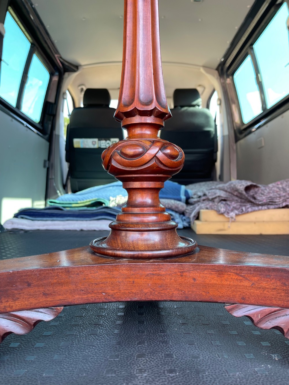 A nineteenth-century mahogany pedestal occasional table featuring a drop-leaf top, fluted central column, and a tri-form base with carved scroll feet on castors. View III