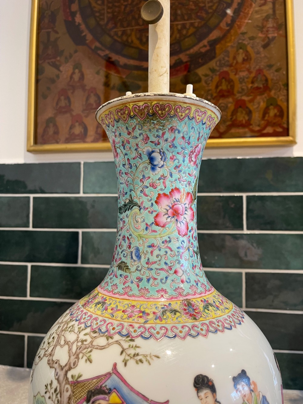 A Chinese Famille Rose porcelain vase mounted as a table lamp with hand-painted figures, floral motifs, brass double sockets, and a carved wooden base. View IV