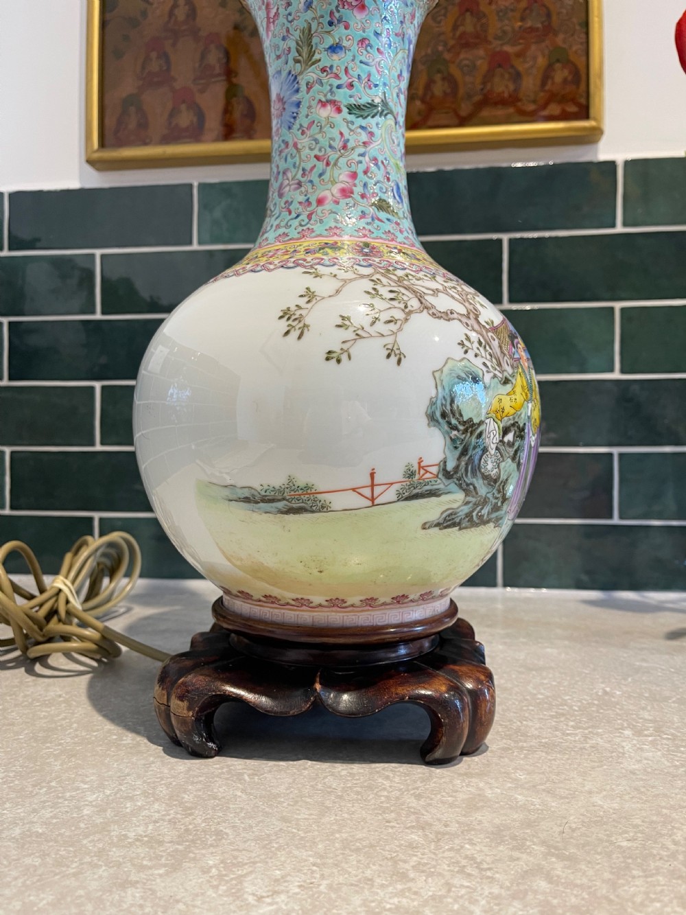 A Chinese Famille Rose porcelain vase mounted as a table lamp with hand-painted figures, floral motifs, brass double sockets, and a carved wooden base. View VII