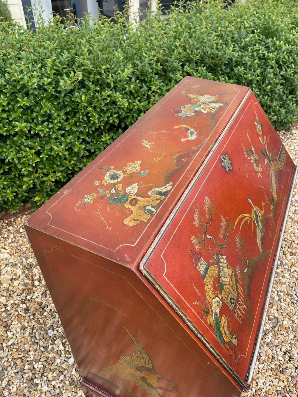 An antique red lacquered fall-front bureau with hand-painted Chinoiserie scenes and a yellow fitted interior featuring cubbies and small drawers. View XIII