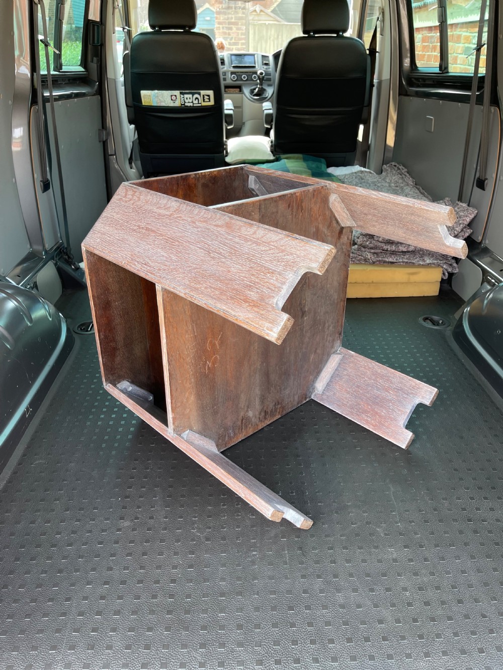A 1930s Heals style limed oak book table featuring an octagonal top, lower open shelf, and angled slab legs with a chalky grain finish. View II