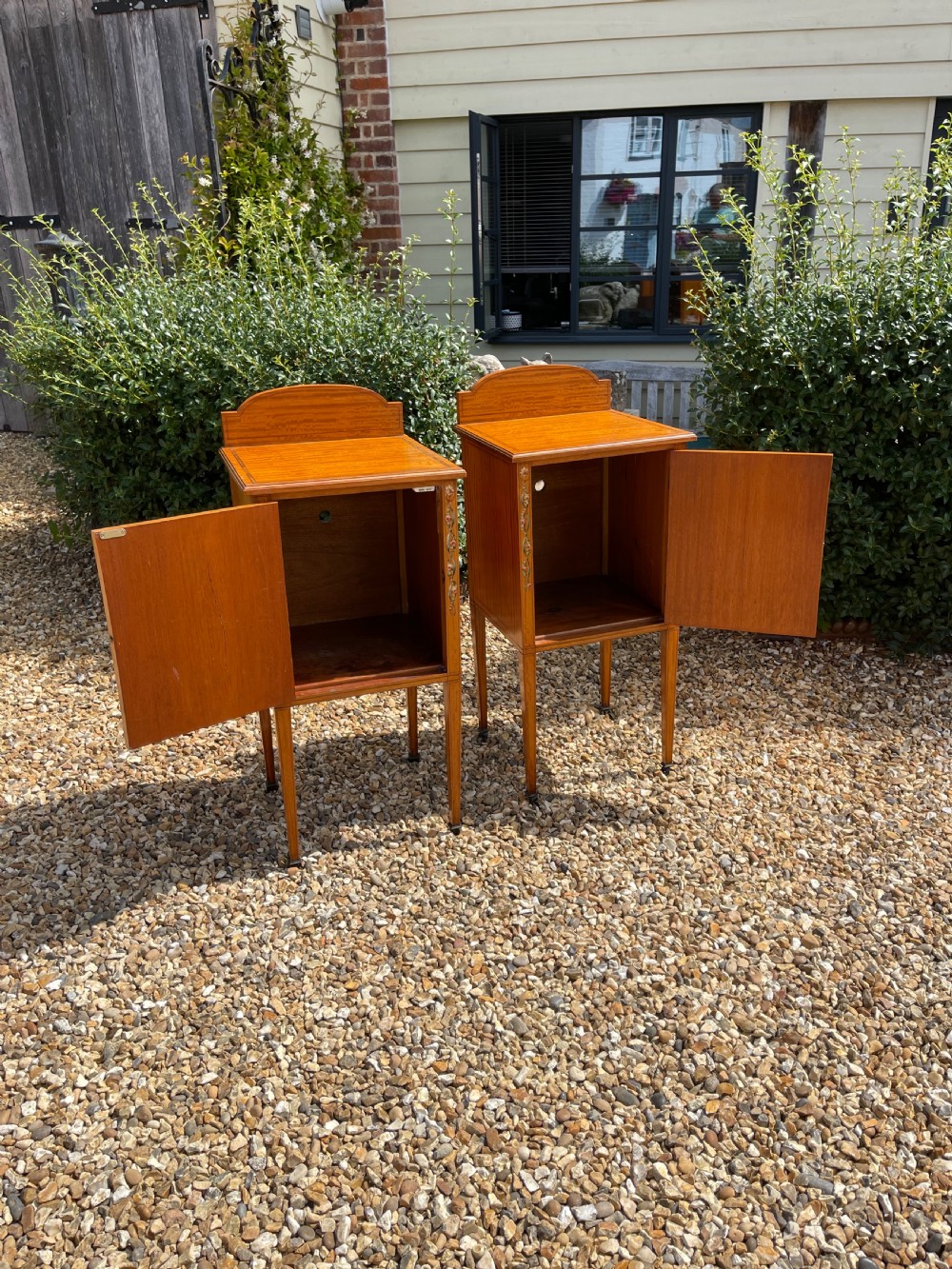 A pair of Edwardian satinwood bedside cupboards featuring diamond marquetry door panels, hand-painted floral stiles, and square tapered legs. View VII