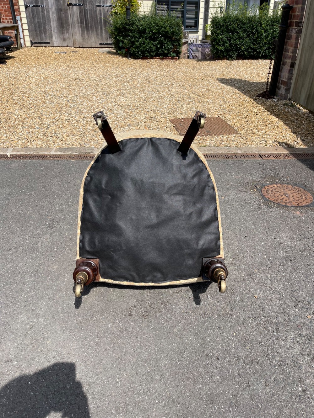 A nineteenth-century spoon back armchair upholstered in gold patterned damask fabric with turned dark timber front legs on brass castors. View V