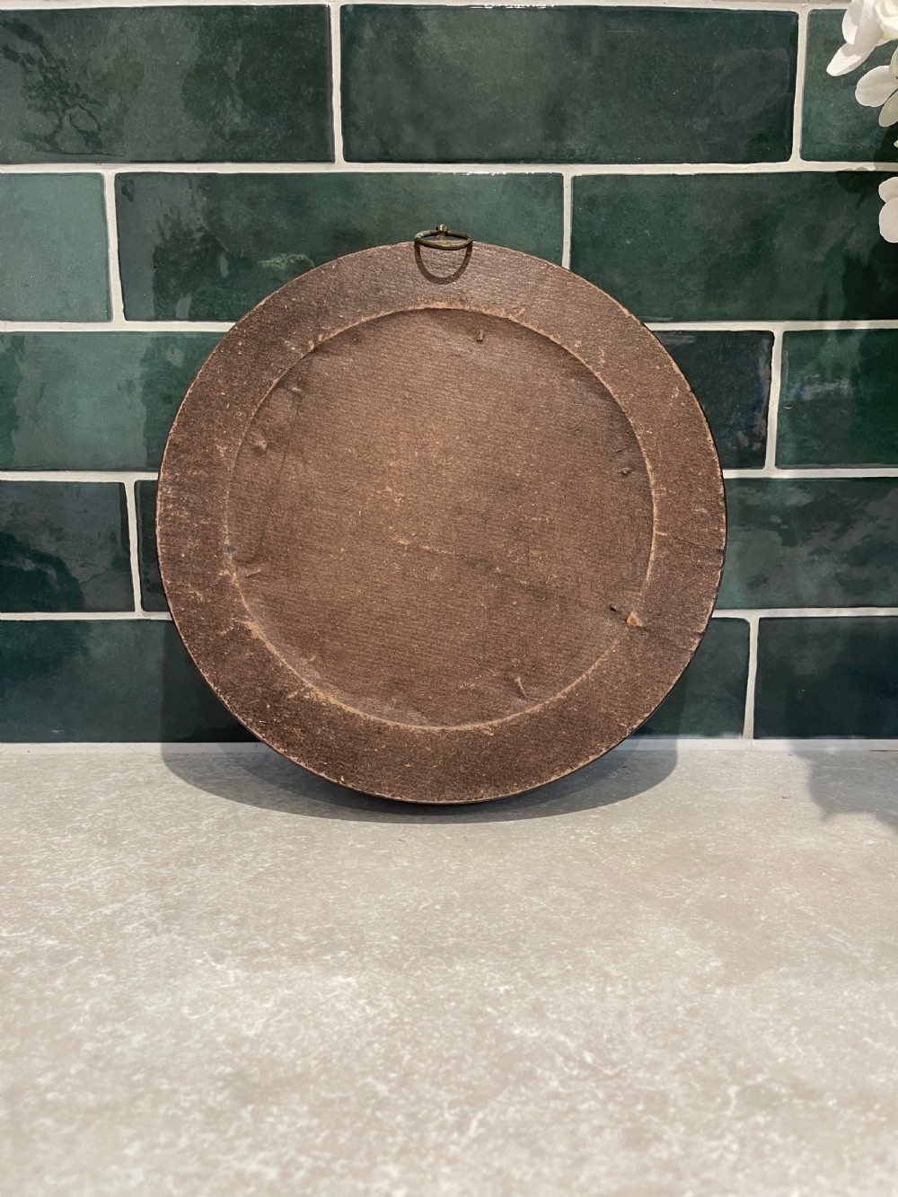 A circular dark mahogany framed wall mirror featuring a central reflective pane set with eight ground circular convex lenses. View II