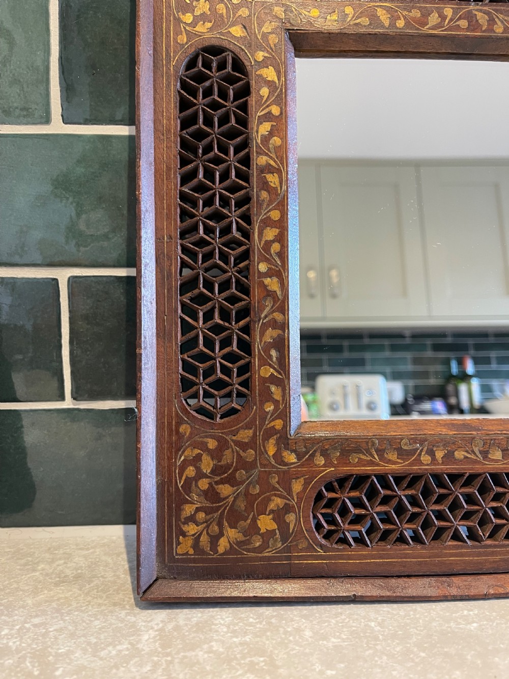 A pair of square dark wood framed mirrors featuring intricate floral brass inlay and pierced geometric jaali lattice panels. View III