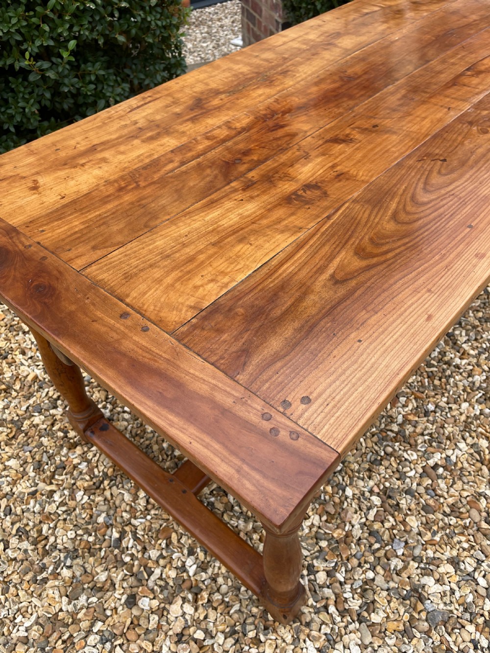 A nineteenth-century rectangular cherrywood table featuring a single frieze drawer, turned legs, and an H-stretcher base. View II