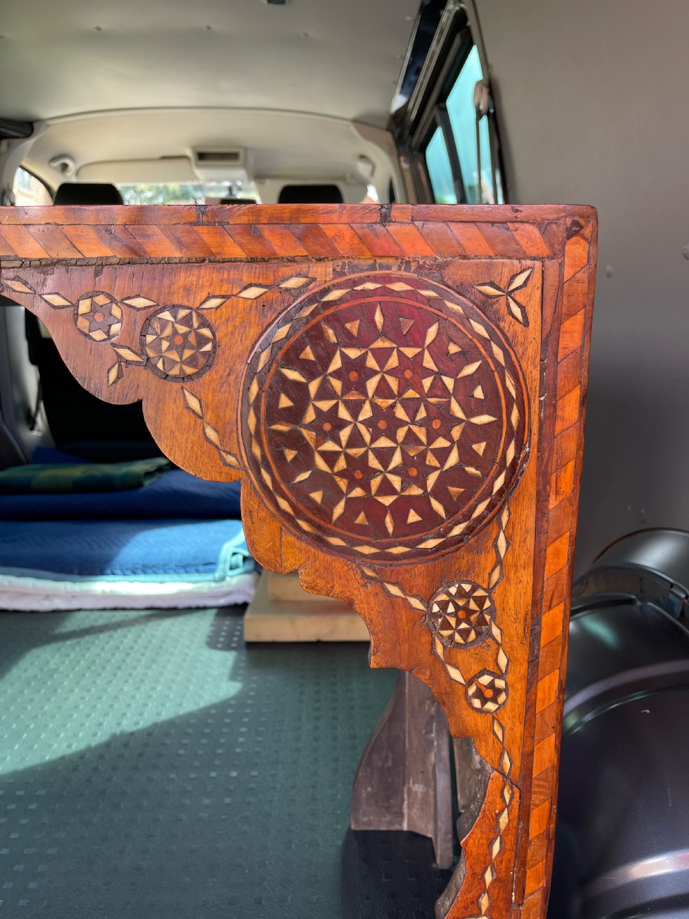 An elongated rectangular walnut console table with intricate geometric bone inlay across the top, apron, and side supports. View VIII