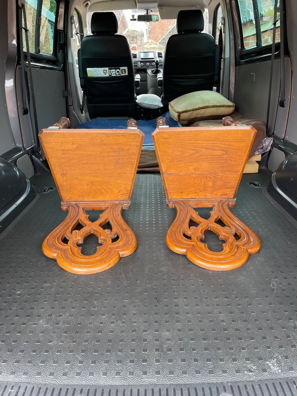 A pair of 19th-century oak hall chairs featuring carved pierced backrests, flat solid wooden seats, and turned front legs. View II