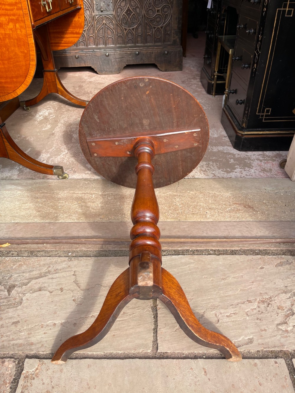 A circular Victorian specimen timber occasional table featuring a starburst parquetry top, a turned central pedestal stem, and three downswept tripod legs. View VI