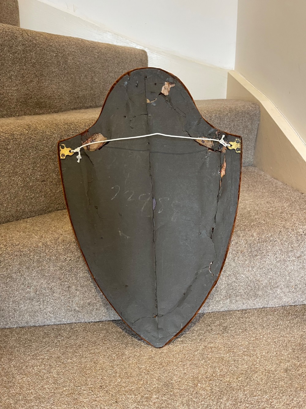 A shield-shaped wall mirror featuring a warm brown velvet fabric frame and an inner border of decorative circular glass beads. View III
