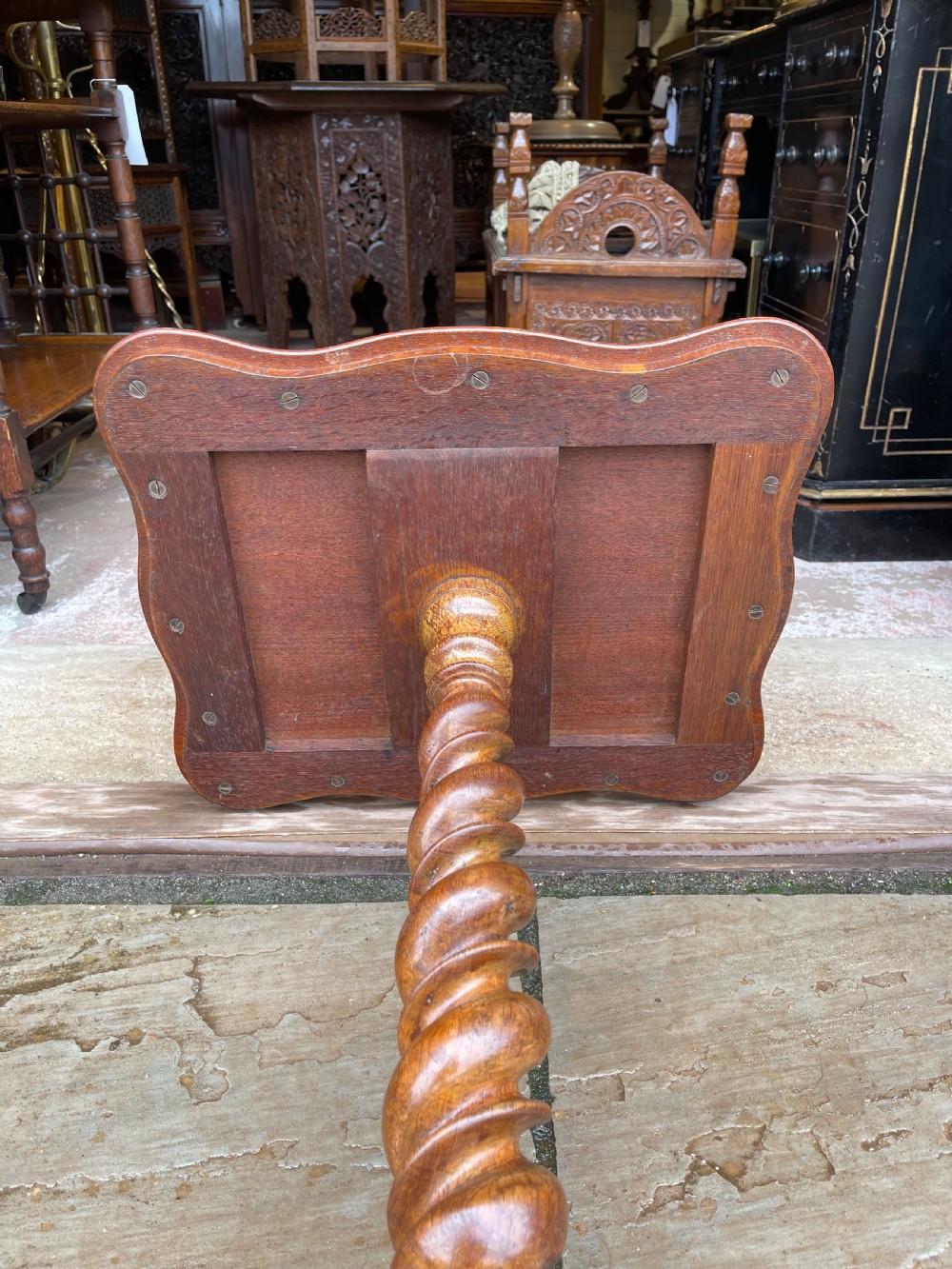 A nineteenth-century burr walnut occasional table featuring a shaped top with intricate floral marquetry, supported by a central barley twist column and a tripod base. View III
