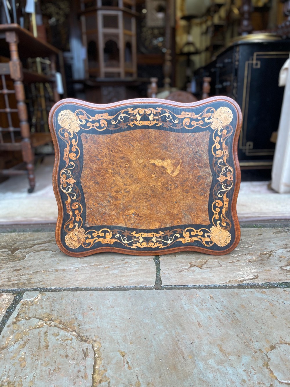 A nineteenth-century burr walnut occasional table featuring a shaped top with intricate floral marquetry, supported by a central barley twist column and a tripod base. View VI