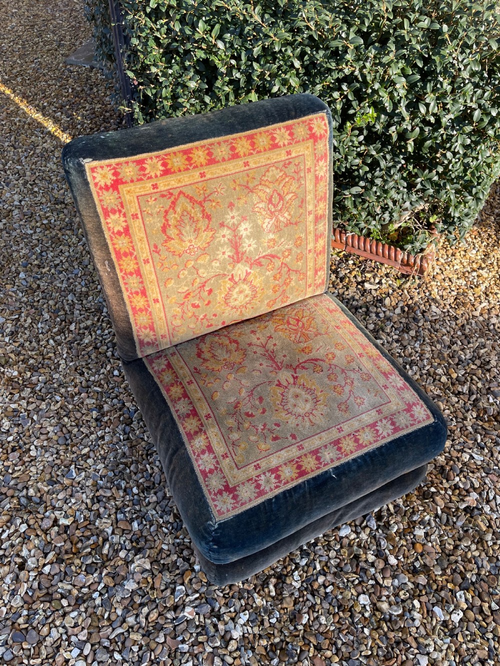 An armless slipper chair upholstered in dark charcoal velvet with a central panel featuring a red and gold oriental carpet pattern. View III