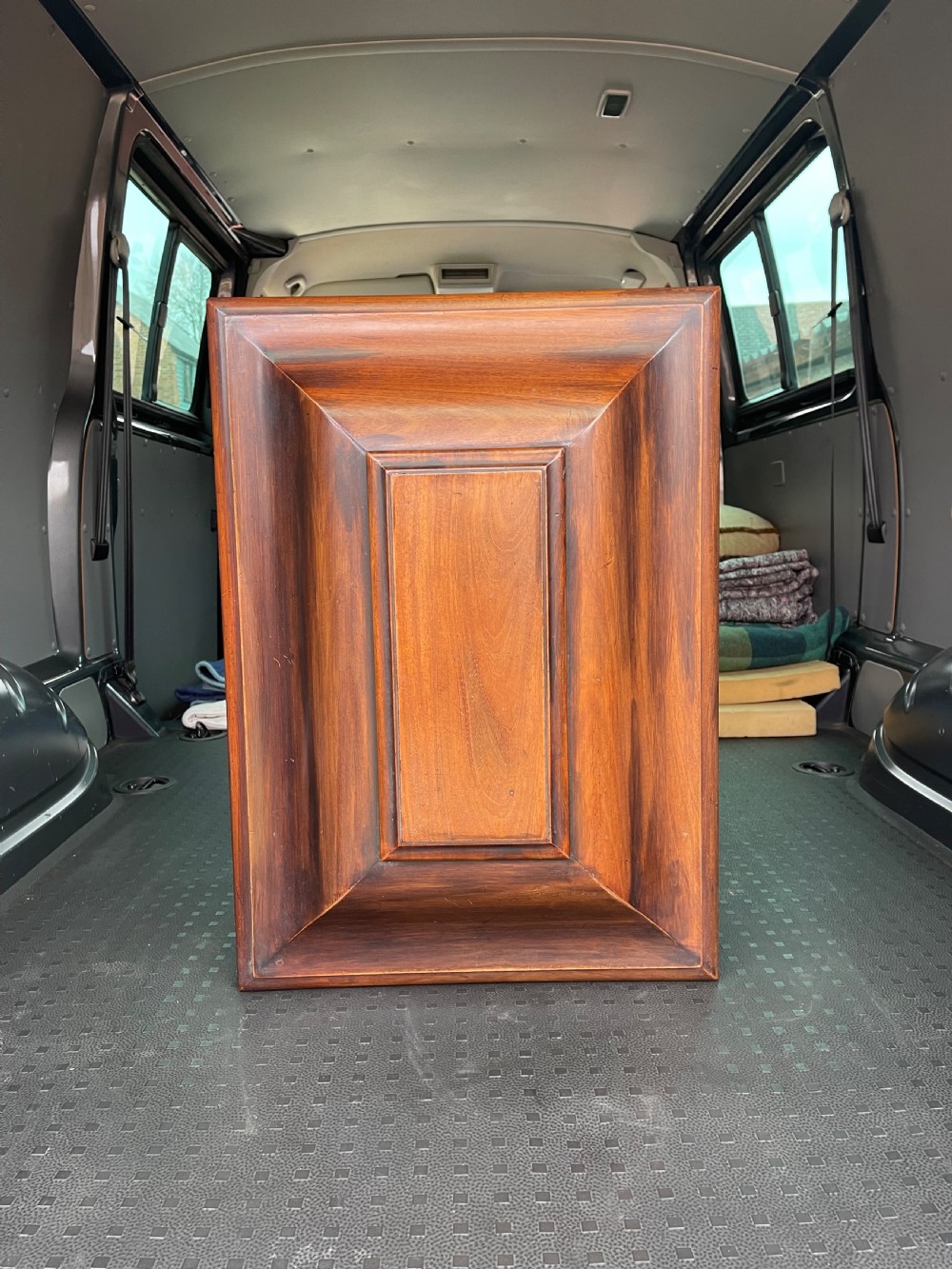 A Regency mahogany cellarette featuring a tapered sarcophagus shape, a hinged lid opening to a hollow interior, ribbed exterior moulding, and turned bun feet. View V