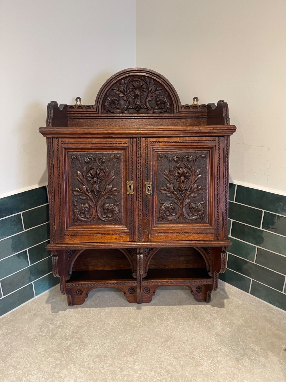 Carved oak wall cupboard 