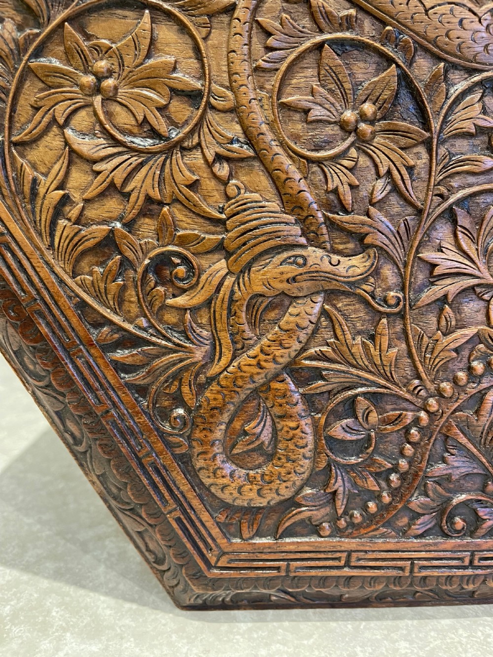 A dark hardwood hexagonal side table featuring intricate hand-carved floral fretwork and pierced side panels with peacock motifs. View III